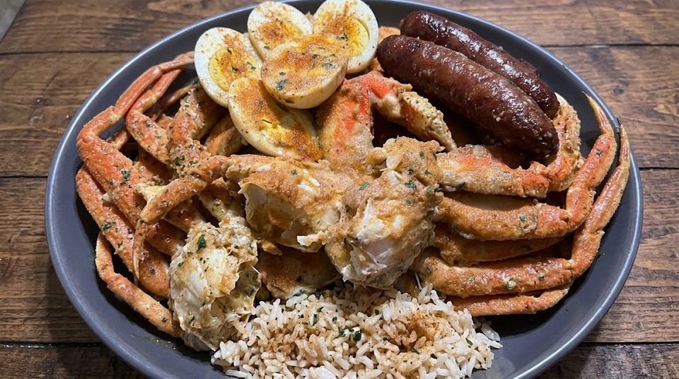 Seafood plate with crab legs and rice.